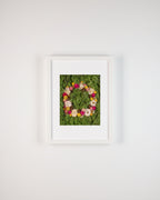 Floral wreath with pink, yellow, and white flowers on a green moss background fine art print