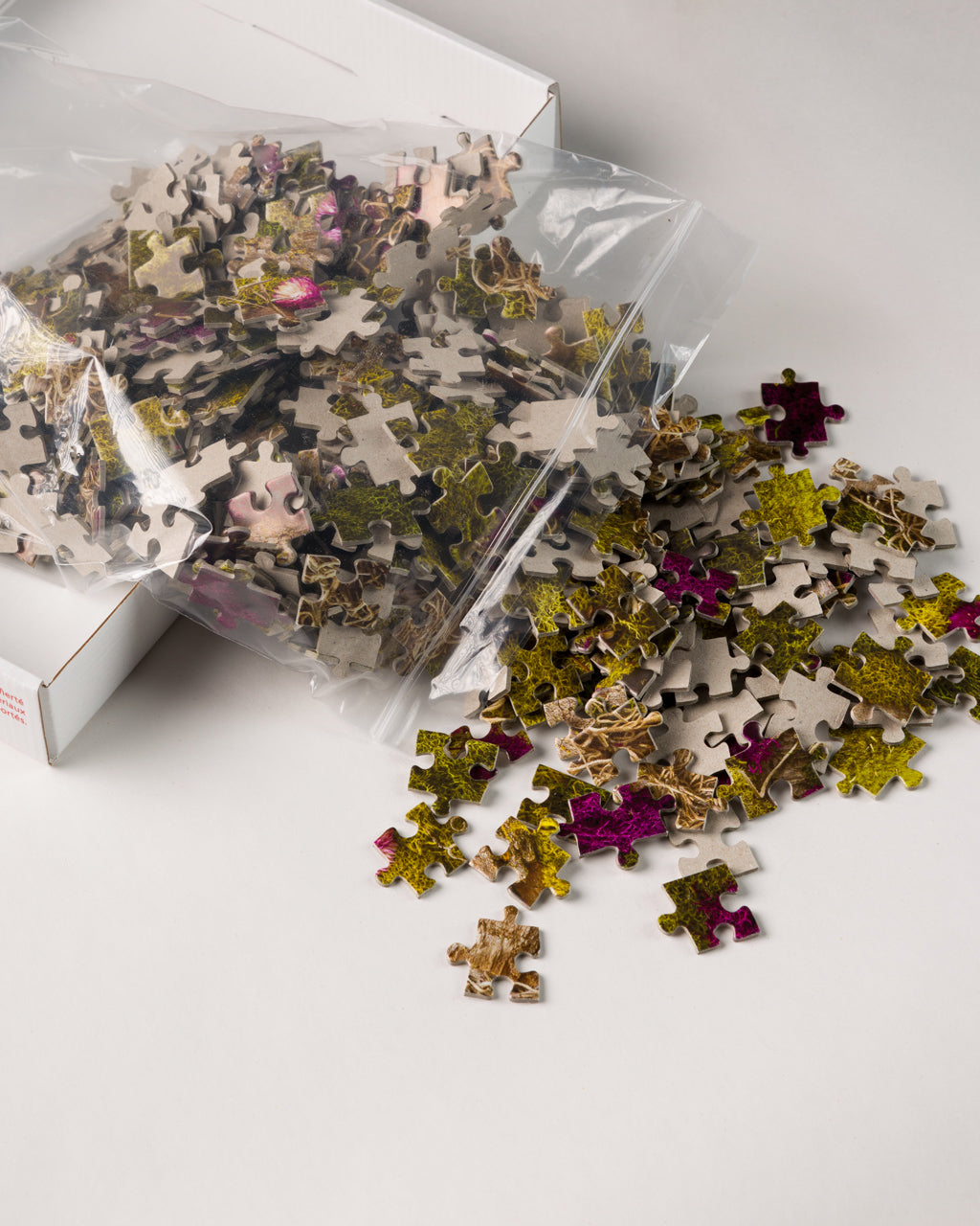 504 piece forest floor jigsaw puzzle pieces flowing out of a bag.