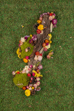 Green forest moss wall with wood bark and colourful flowers fine art print