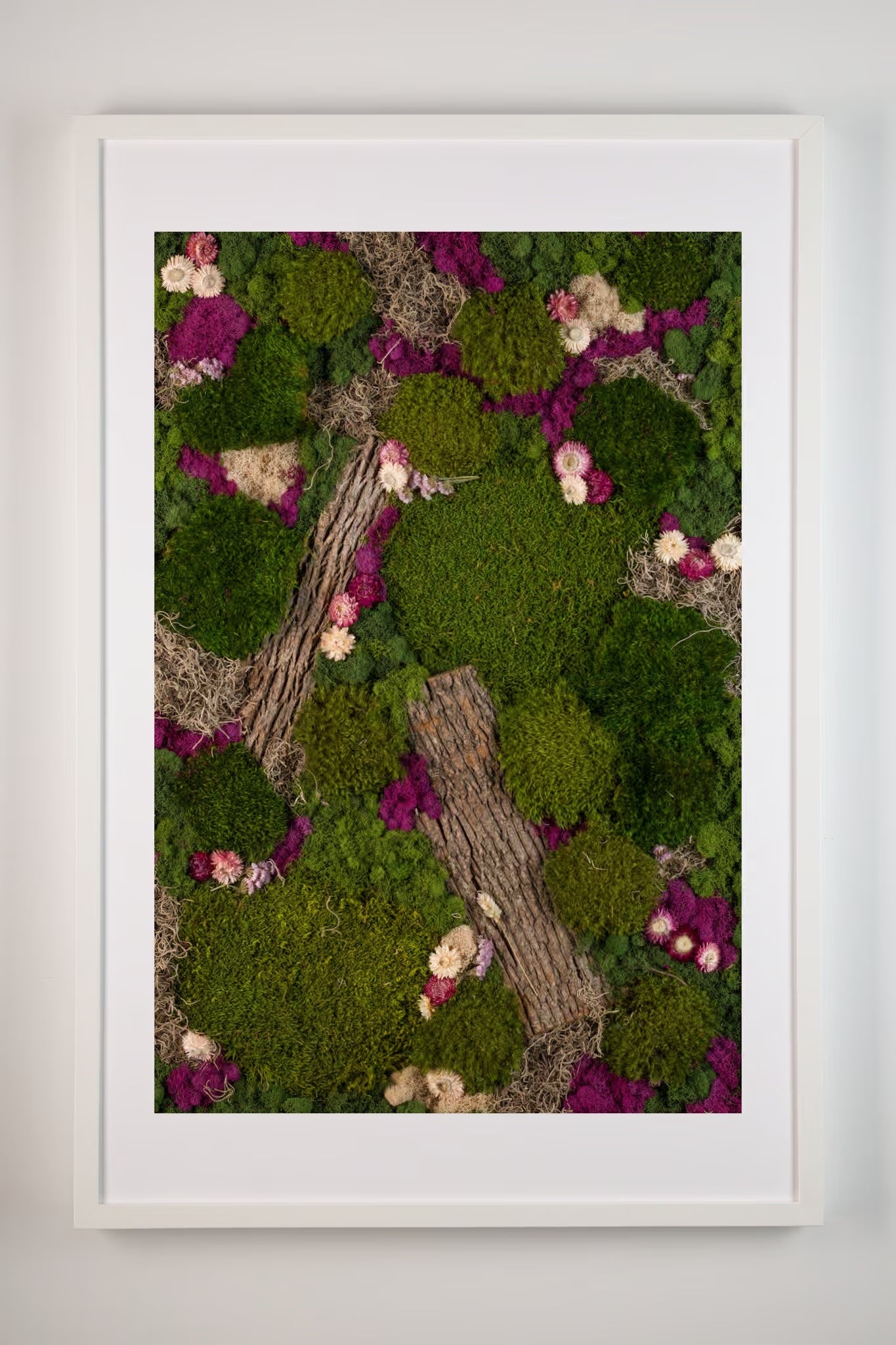 Framed fine art print of moss wall with purple and white flowers and wooden bark