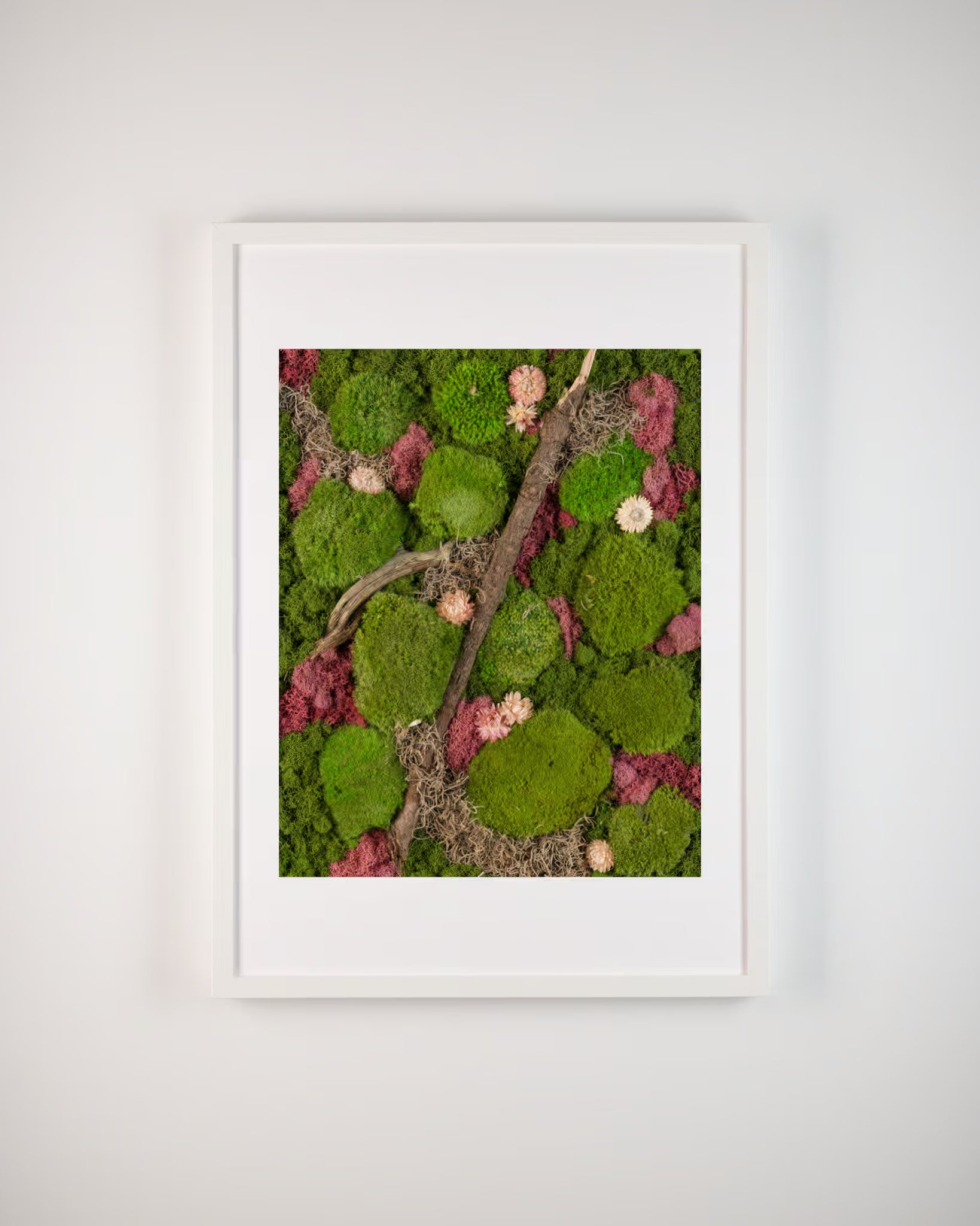 Framed artwork with green and pink moss wall with white flowers and a wooden branch fine art print